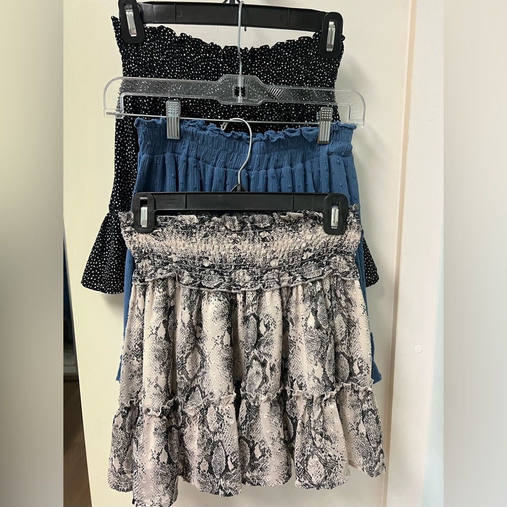 This is a lot of three mini ruffled skirts: blue, animal print and black/white.